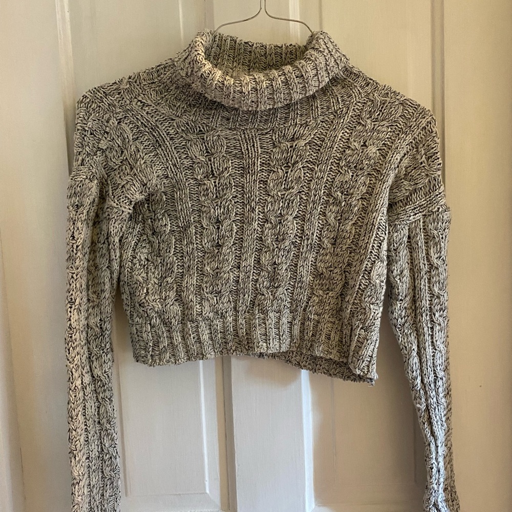 Cropped black and white turtleneck sweater.